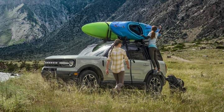 An exterior shot of a Ford Bronco Sport with a Kayak on the roof.