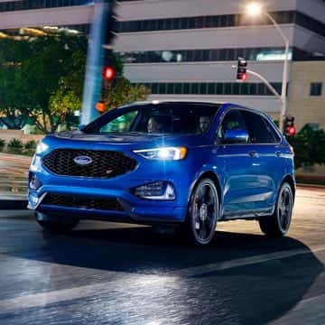 Blue Ford Edge ST driving at night