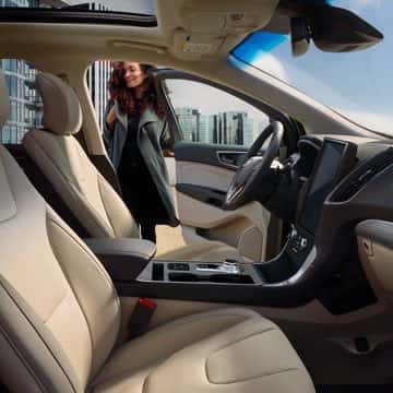 Woman opens driver side door of Ford Edge ST