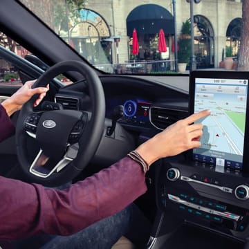 An interior shot of a person touching the touch screen display