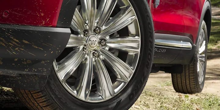 A side shot of a Red Ford Explorer parked 
