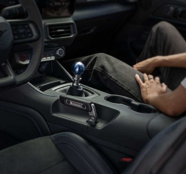 man in the passenger seat of a 2024 Mustang