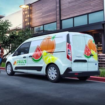 An exterior shot of a Ford Transit Connect Cargo Van customized for a food delivery business.
