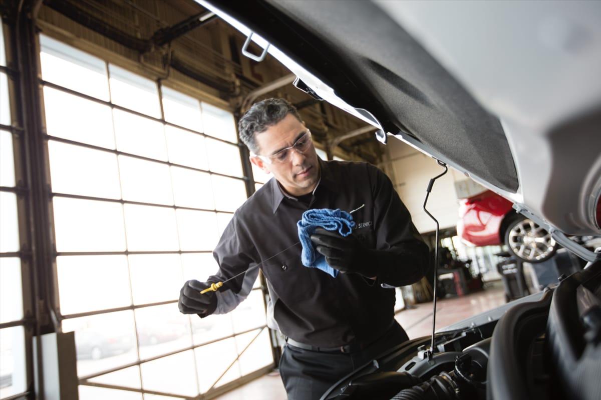 A service technician doing an oil change