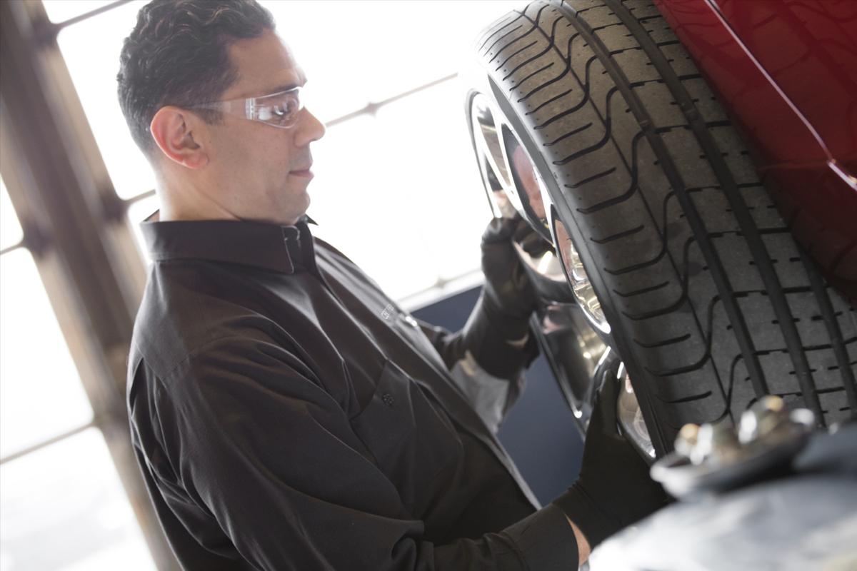 Service technician installing a new tire.