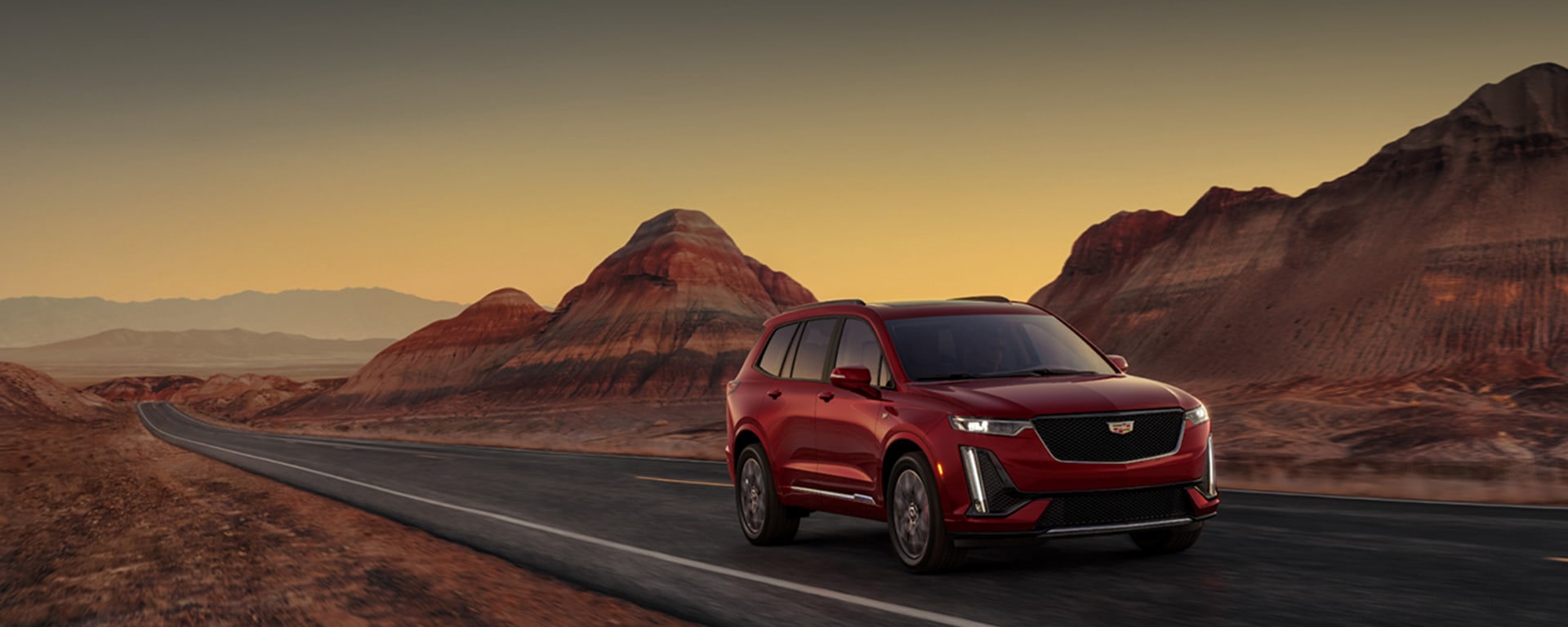 Cadillac XT6 driving past desert mountains