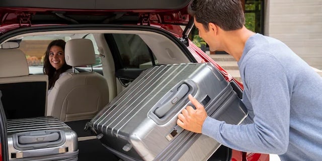 2022 Buick Envision owner loading luggage in the rear