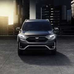 Front View of a Grey Honda CR-V Parked in Front of City Skyline