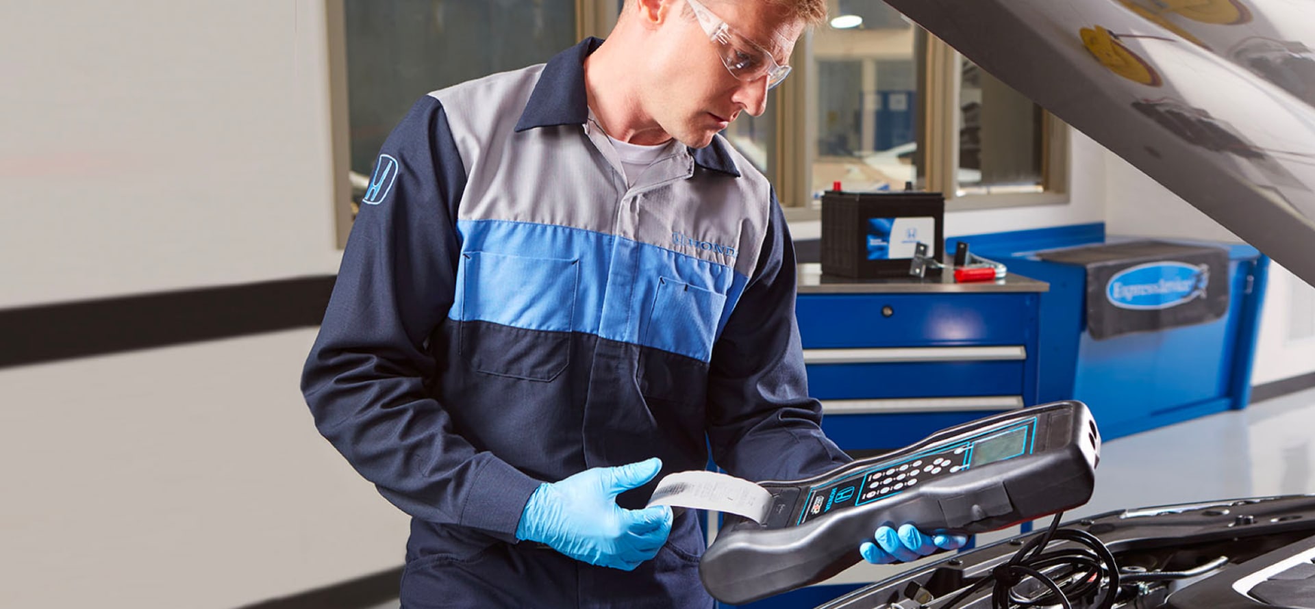 Honda service technician running diagnostics with an engine checker