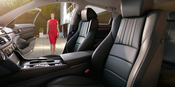 Interior shot of the front seat with owner walking towards passenger seat
