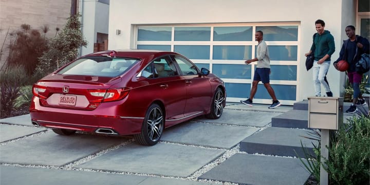 Red Honda Accord parked in driveway.