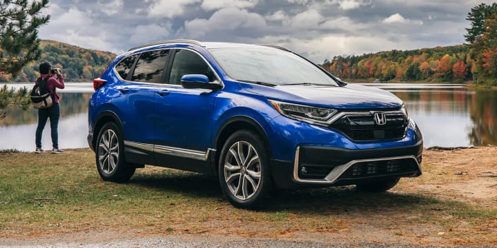 Blue CRV parked with a lake as a backdrop