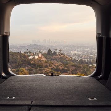 CR-V parked with rear hatch open facing city skyline