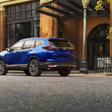 A blue Honda CR-V parked outside a shopping center