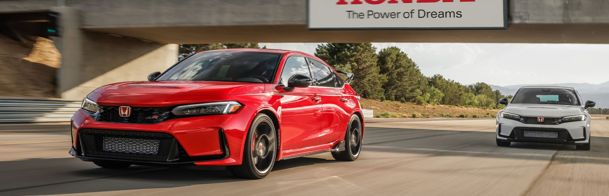 A red Honda Civic Type R driving down straightaway