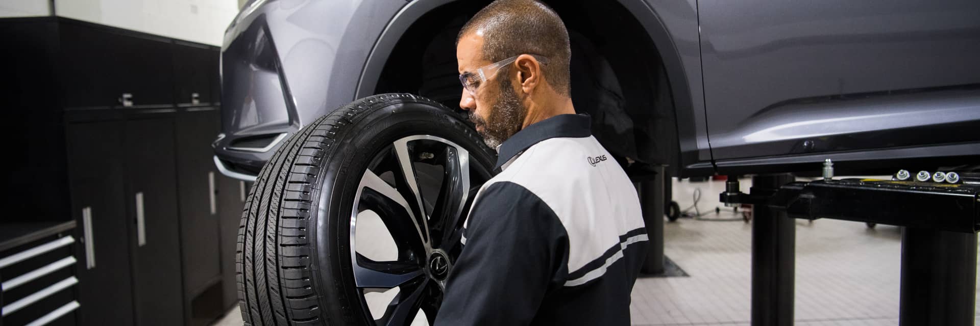Lexus service technician replacing a wheel