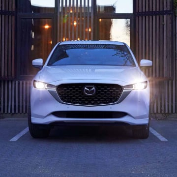 Front view of a Mazda CX-5 with headlights on