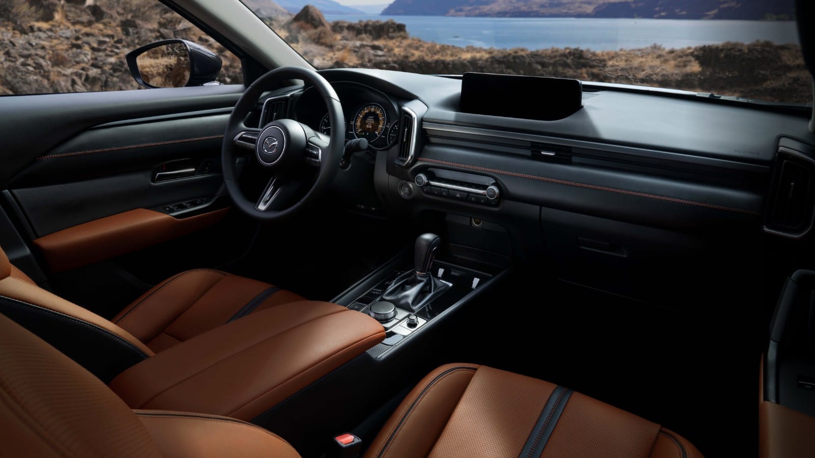 Interior shot of driver and passenger seat along with steering wheel and dash