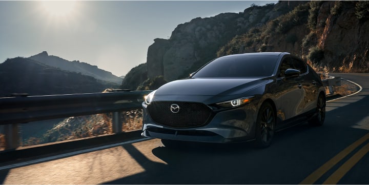 2023 Mazda3 Hatchback driving on mountain highway
