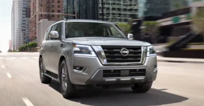 Silver Nissan Armada driving towards viewer on a city road