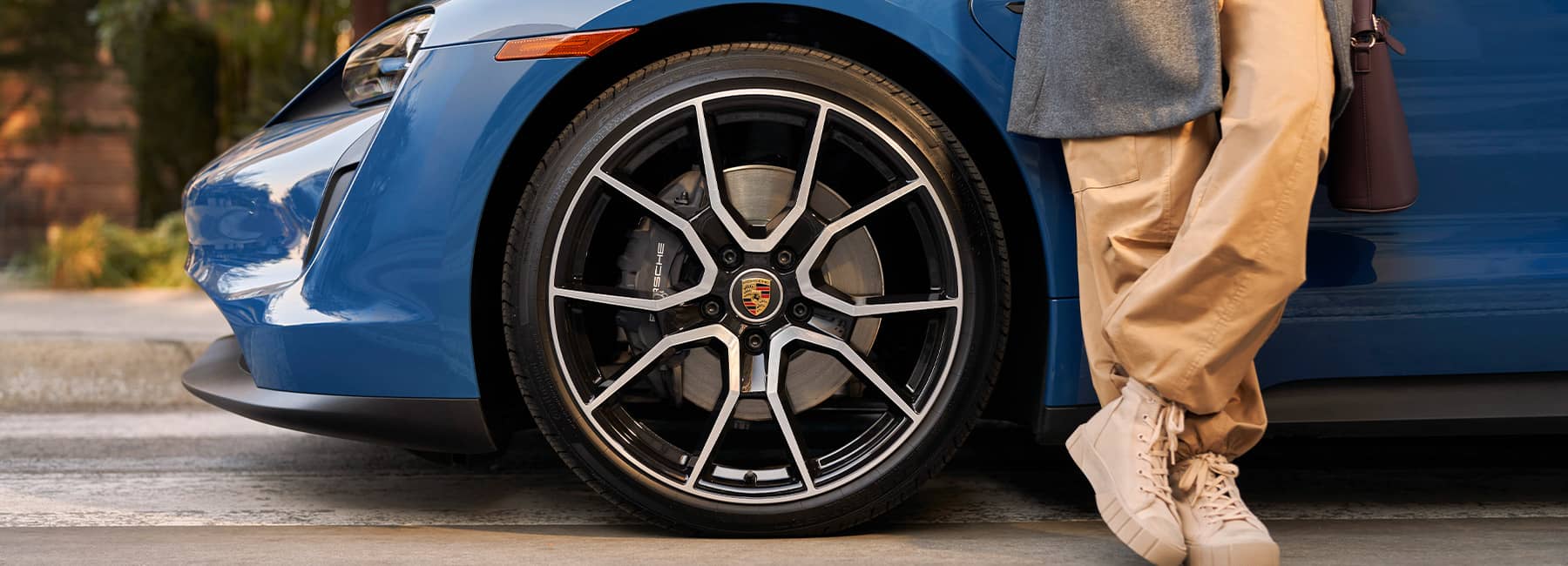 Front wheel closeup on a Blue Porsche Taycan Turbo S