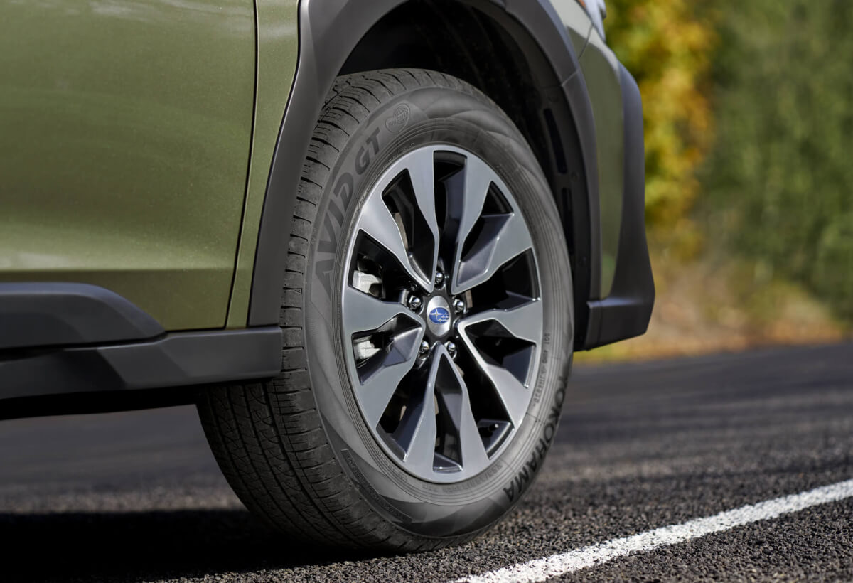 Close-up view of a Autumn Green Metallic 2023 Subaru vehicle wheel and tire.