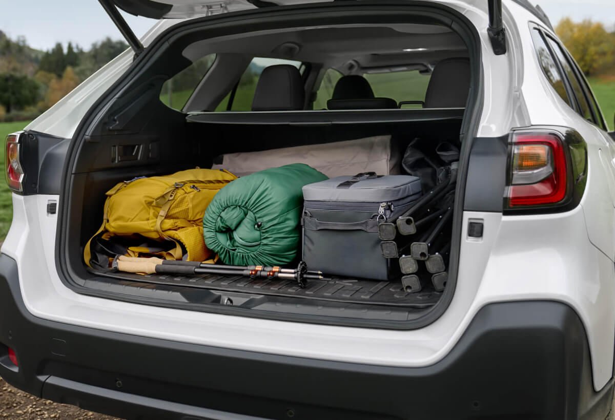 Open rear gate of a 2023 Subaru SUV packed for a camping adventure